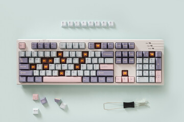 Mechanical new keyboard with colorful pastel keycaps on blue background. Custom build keyboard....