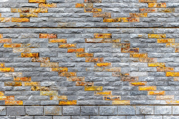 Patterned brick wall with gray and orange textured stone design