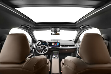 A photo captured from the middle of the back seat of a modern passenger car with digital touch...