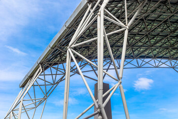 Architectural steel truss structure against clear blue sky