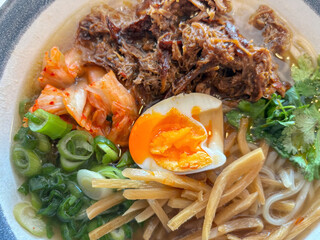 Tantanmen beef brisket ramen, slow-cooked korean barbecue beef brisket topped on ramen noodle in an...