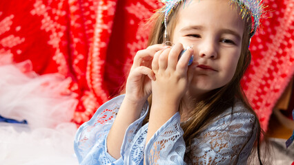 Christmas time, cute children play cuddling and having fun sitting on the floor near the festive...