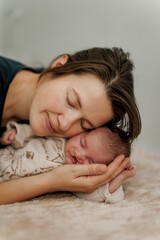 A serene moment of a mother holding her sleeping baby close to her chest, showcasing tenderness and love.