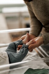 A newborn baby sleeping peacefully in a hospital bassinet, wearing a cozy outfit.