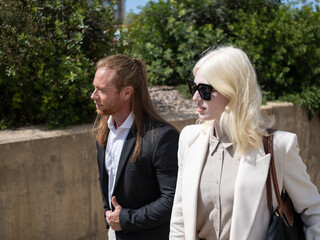 Business professionals walking outdoors on a sunny day