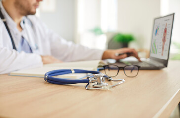 Stethoscope medical instrument close up, professional doctor physician or cardiologist at desk...