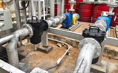 Industrial pump system with pipeline connections, strainers, and electric motors. Used for fluid transport in factories, water treatment, chemical plants, or energy production systems.