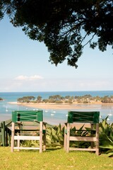 Two Wooden Camping Chairs Overlooking Tairua River in Shade