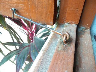 Rusty locking latch on a dirty and dusty window