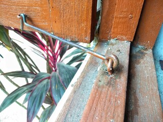 Rusty locking latch on a dirty and dusty window