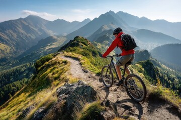 Mountain biking adventure with man on trail overlooking breathtaking alpine mountain range