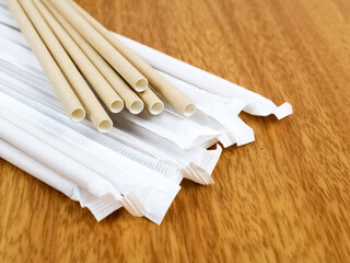 Brown paper drinking straw isolated on wooden background