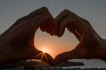 Hands Heart Sunset - Silhouette of hands forming heart shape against sunset sky.