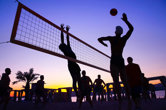 silhouette of beach Volleyball player on the beach in sunset - Powered by Adobe