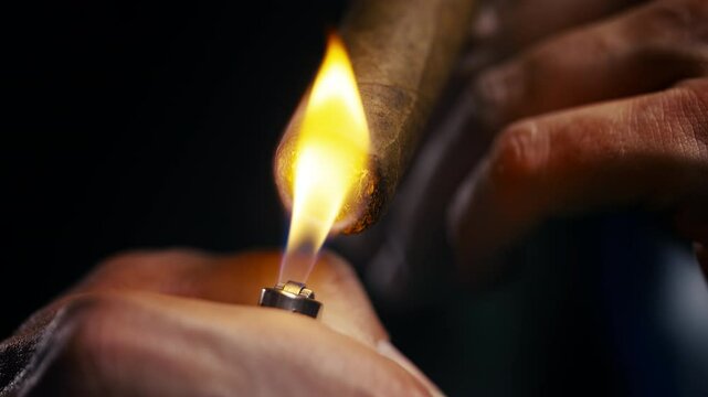 Close-up of rich bearded man lighting cigar, enjoying luxury tobacco in style