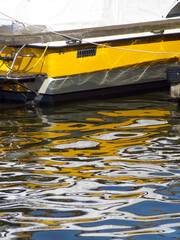Boat. Yellow boat background. Boat or yacht reflexion in water. Abstract distorted boat elements in...