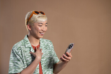 Young Man Smiling at Phone in the Studio