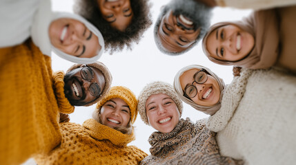A diverse group of smiling friends huddle together, celebrating their joyful connection and shared community.