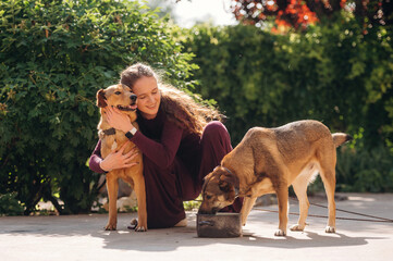 Peaceful and happy. Woman is with dogs outdoors