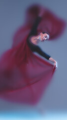 Elegant faded dance portrait with red fabric, mid motion. Dynamic ballet gesture with moody,...
