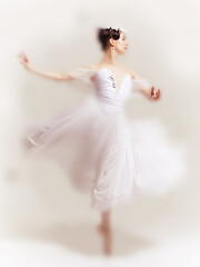 Romantic faded ballet scene showcasing dancer in white dress caught mid spin, radiating elegance...