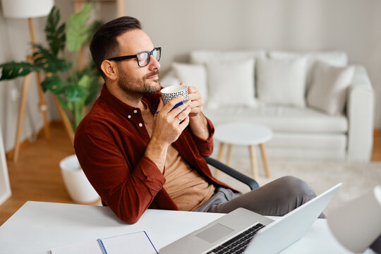 Freelancer enjoying a coffee break while working from home office