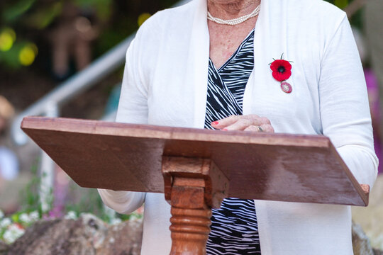 Woman making a speech at an Anzac service