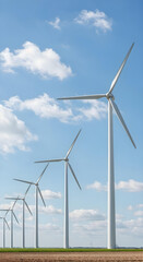Fototapeta premium A wind turbine stands symmetrically against a clear blue sky, emphasizing clean energy and minimalist design. 