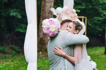  happy, laughing bride and groom at the wedding at the open wedding. Emotional hug at the YES WORD.