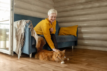 A Senior Woman Happily Enjoying Quality Time with Her Beloved Cat in a Cozy Living Room Space
