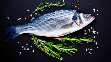 Fresh fish dorado. Dorado and ingredients for cooking on a table. Fresh raw dorado fish with spices...