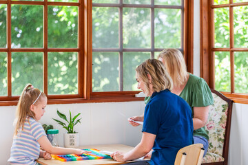 Mum and speech pathologist consulting over childs assessment in clinic