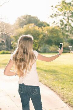 Teen girl taking a selfie in the afternoon light