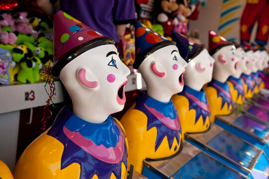 Row of clown heads with mouths wide open