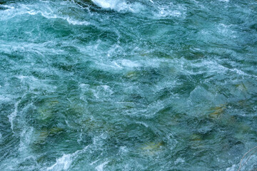 Dynamic river flow. Water surface of flowing Turquoise waters as they cascade and ripple. Use for...