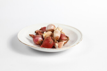 red and white onion in a plate isolated on white background
