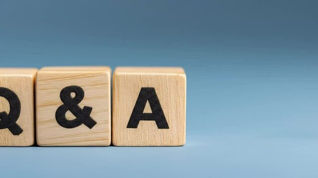 Three light wooden blocks with black letters "Q", "&", and "A" spell "Q&A" on a plain blue background.