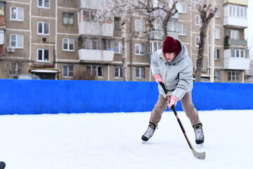 People skate and play ice hockey in the yard