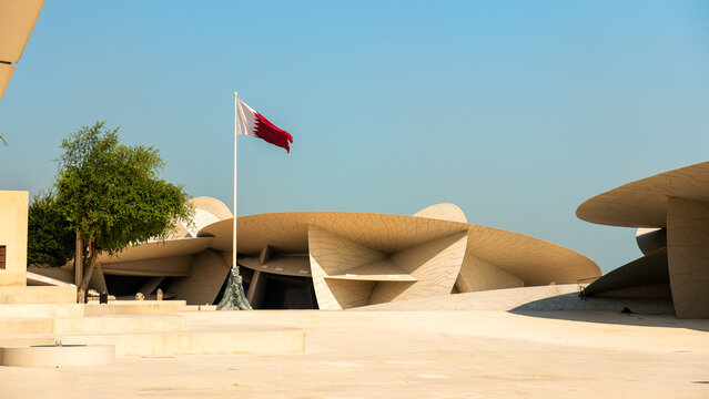 beautiful image of the national museum of Qatar and the Qatar national flag in the same frame