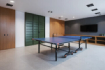 Fototapeta premium Blurry photo of a table tennis table interior inside a house, the board uses modern themed wood without any people.