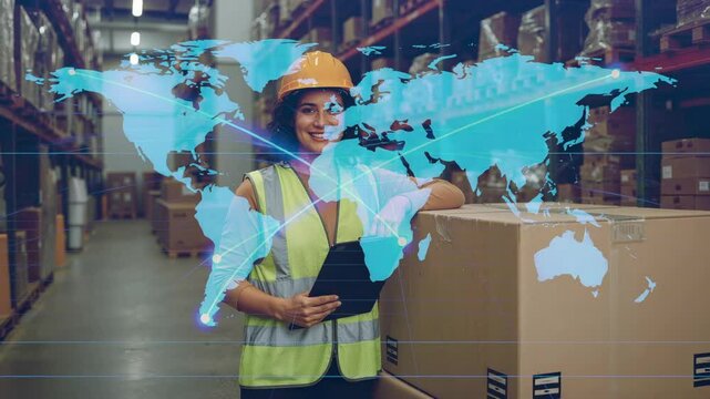 Projecting map in warehouse over worker wearing hard hat holding tablet, showing global network - Powered by Adobe
