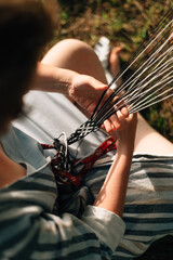 The weaver weaves a belt