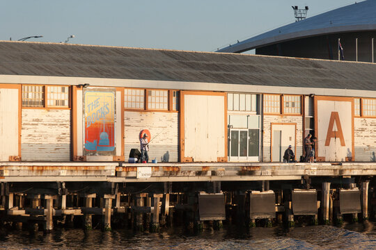Men fishing near A Sheds at Fremantle Ports