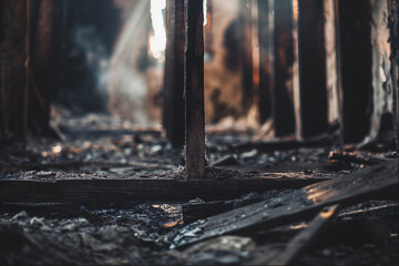 Burnt industrial interior with collapsed roof and sunlight