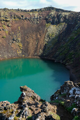 Kerid Volcanic Crater Lake in Iceland with Striking Turquoise Water and Red Volcanic Rock, A Unique...