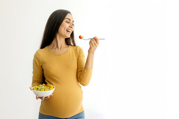 Vitamin Food. Happy Young Pregnant Woman Eating Vegetable Salad While Standing Near Window At Home,...