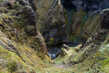 Majestic Fjaðrárgljúfur Canyon in Iceland, Featuring Steep Moss-Covered Cliffs and a Winding River Below, Natural Geological Wonder