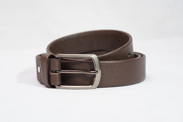 Full view of a coiled, dark brown textured leather belt with a rectangular gunmetal buckle, perfect...