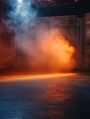 Fototapeta premium Illuminated by orange and blue lights the vacant studio features a textured concrete floor and walls. Soft fog wafts through the air enhancing the film like mood