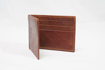 Open light brown leather wallet, showcasing its multiple card slots and minimalist, functional...